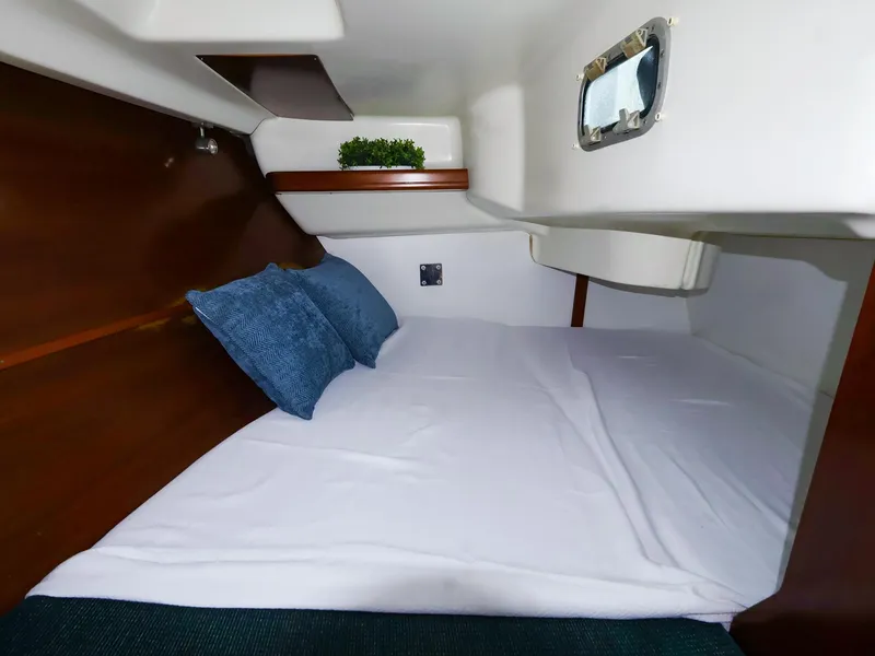 Slide: The Image of Cozy cabin interior of 1999 Beneteau 361 sailboat with bed and porthole. - 44