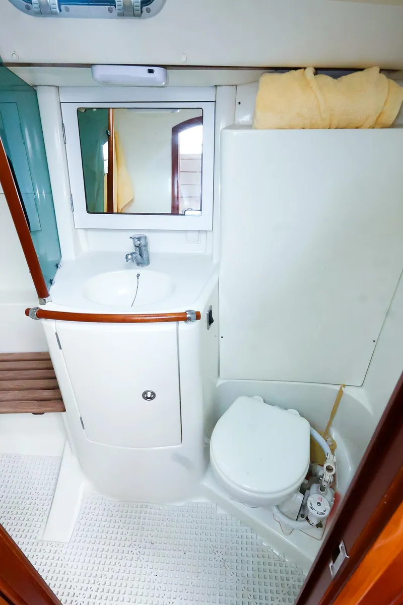 Slide: The Image of 1999 Beneteau 361 yacht bathroom with sink, mirror, and toilet. - 45
