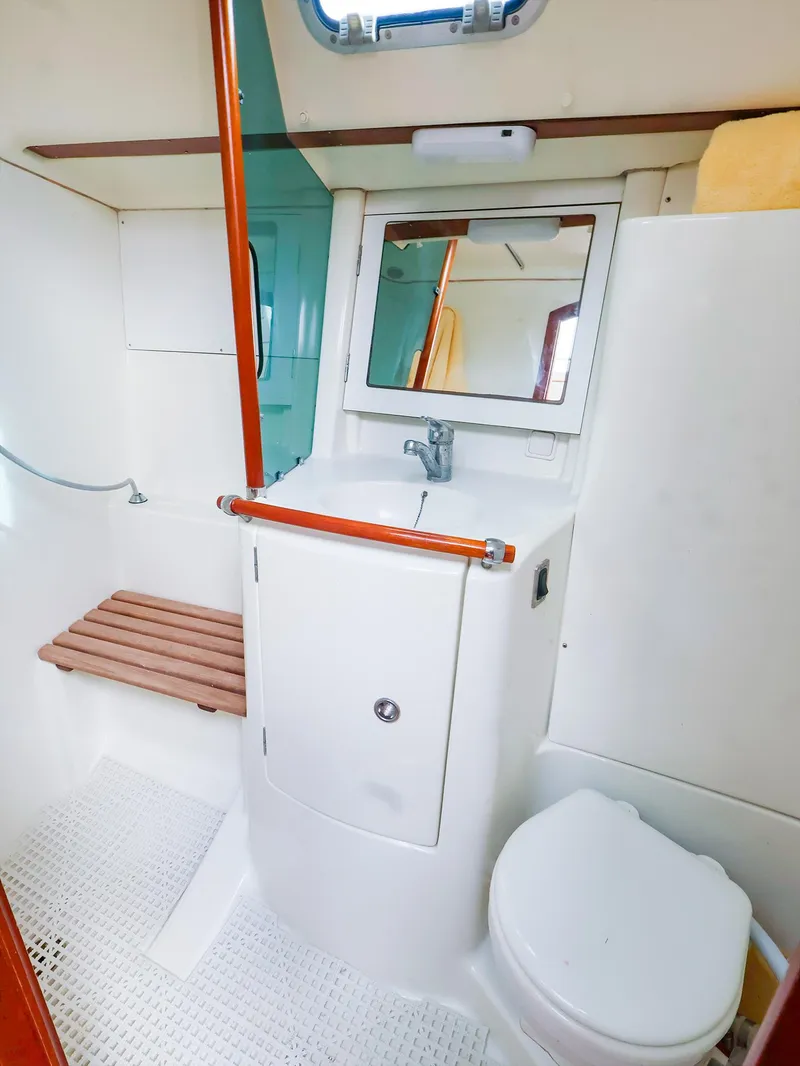Slide: The Image of 1999 Beneteau 361 yacht bathroom with sink, mirror, and toilet. - 46