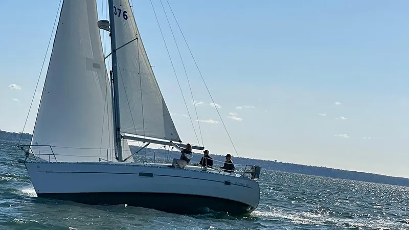 Slide: The Image of Sailing on a 1999 Beneteau 361 yacht in open waters under clear skies. - 48