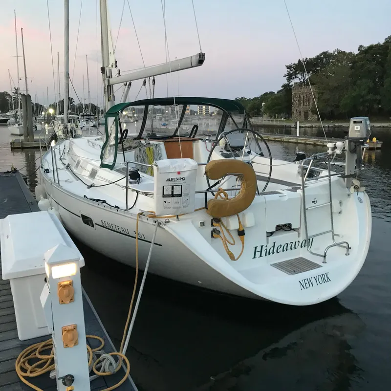 Slide: The Image of Sailboat "Hideaway," Beneteau 361, 1999 model, docked at marina during sunset. - 6