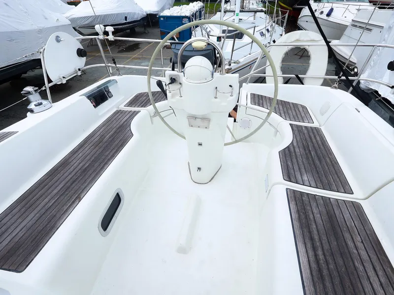 Slide: The Image of Cockpit of 1999 Beneteau 361 sailboat with wooden deck and steering wheel. - 7