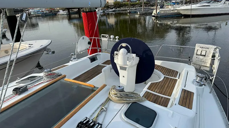 Slide: The Image of 1999 Beneteau 361 sailboat deck with steering wheel, docked in marina. - 8