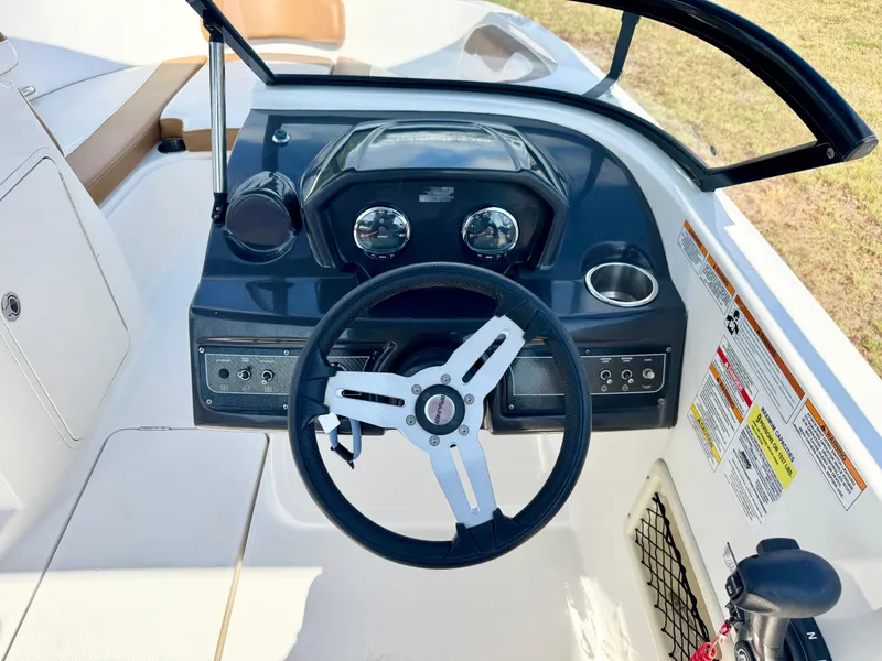 Slide: The Image of 2021 Bayliner VR5 OB boat dashboard with steering wheel and control panel. - 13