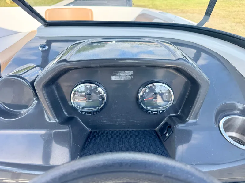 Slide: The Image of Dashboard of 2021 Bayliner VR5 OB boat with gauges and cup holder. - 14