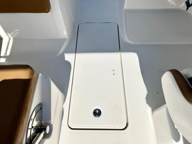 Slide: The Image of 2021 Bayliner VR5 OB boat interior with white deck and brown seating. - 16