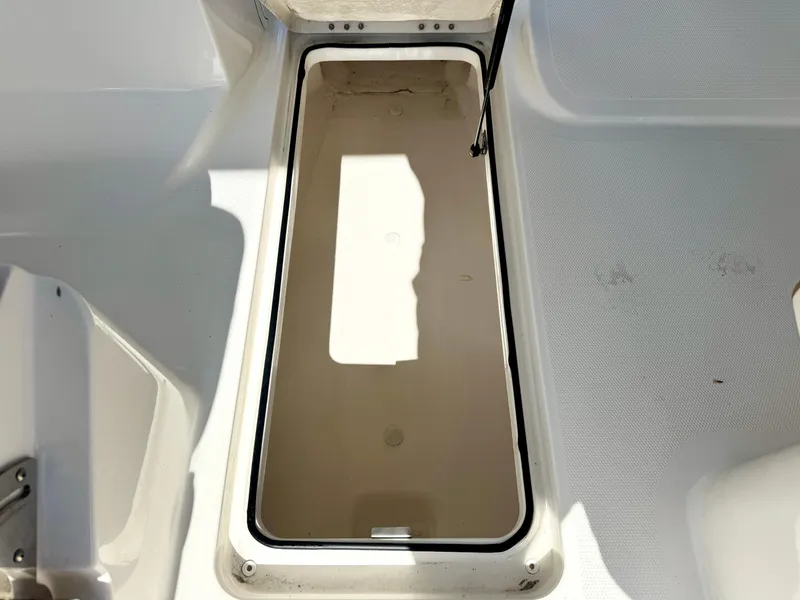 Slide: The Image of 2021 Bayliner VR5 OB storage compartment, open and empty, with white interior. - 17