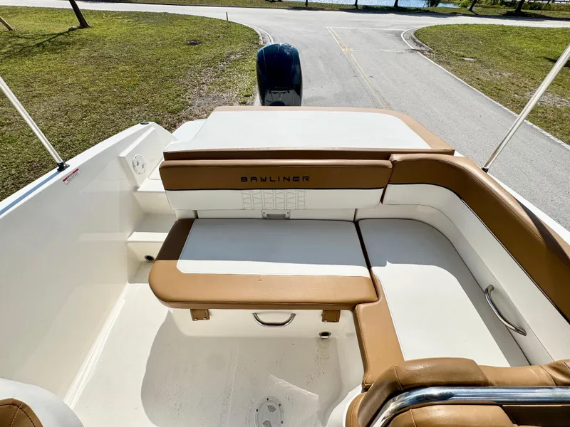 Slide: The Image of 2021 Bayliner VR5 OB boat interior with tan seating and white deck. - 18