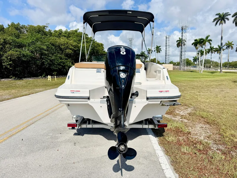 Slide: The Image of 2021 Bayliner VR5 OB boat on trailer, rear view, with outboard motor and canopy. - 2