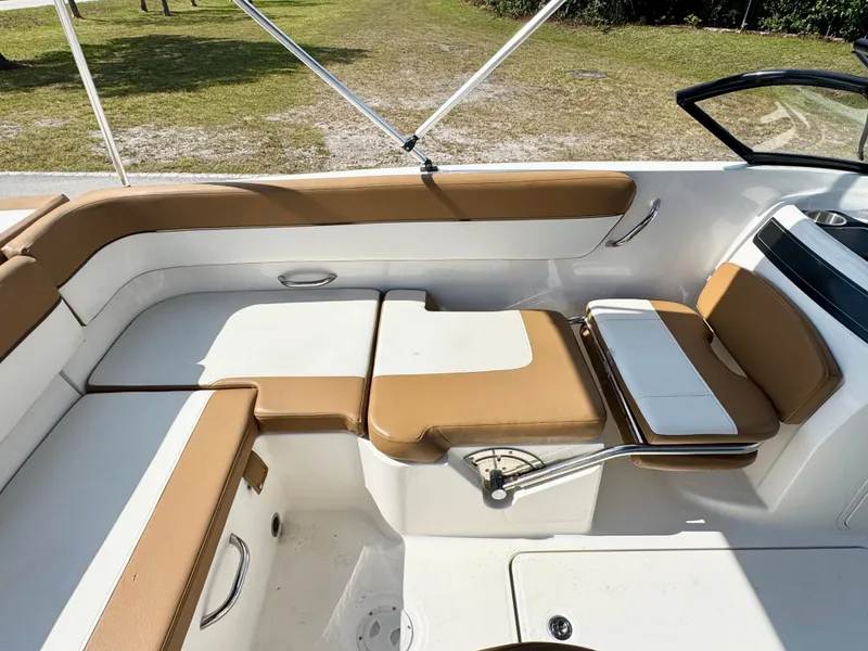 Slide: The Image of 2021 Bayliner VR5 OB boat interior with tan and white seating, open-air design. - 20
