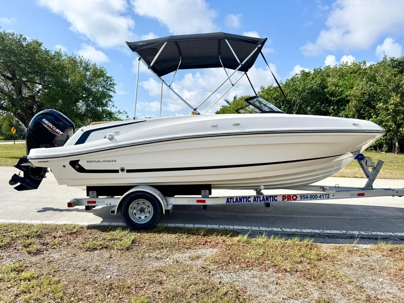 Slide: The Image of 2021 Bayliner VR5 OB boat on trailer, parked outdoors under a blue sky. - 4