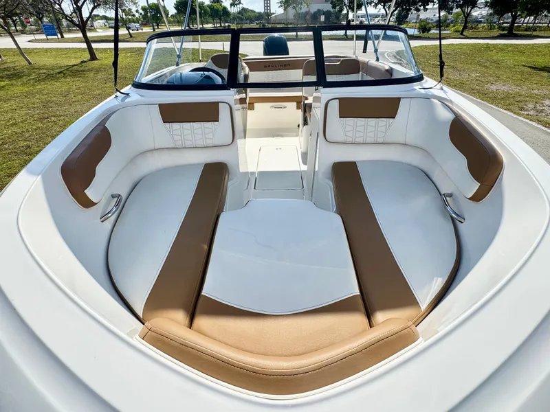 Slide: The Image of 2021 Bayliner VR5 OB boat interior with tan and white seating, open deck view. - 6