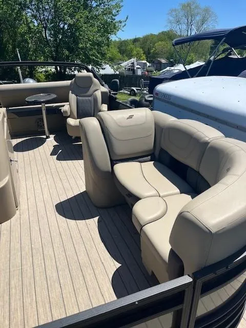 Slide: The Image of 2023 Starcraft SLS3 Q DH pontoon boat with beige seating and wooden deck. - 10