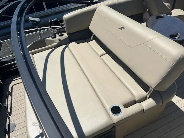 Slide: The Image of 2023 Starcraft SLS3 Q DH boat interior with beige seating and cup holder. - 3