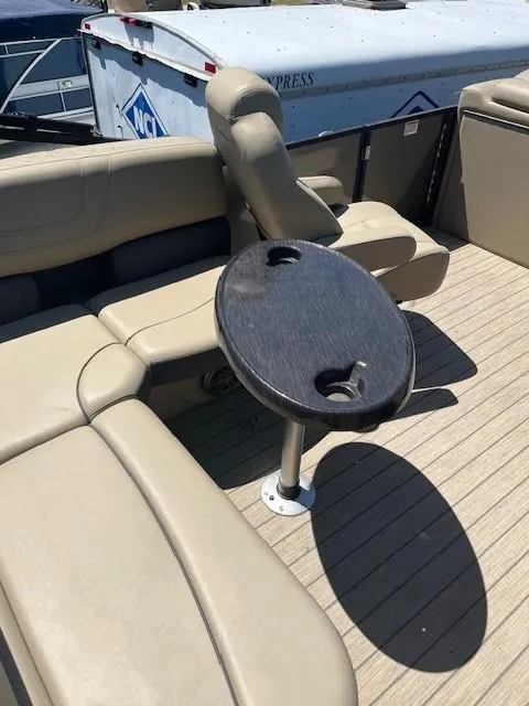 Slide: The Image of 2023 Starcraft SLS3 Q DH boat interior with beige seating and a small round table. - 4