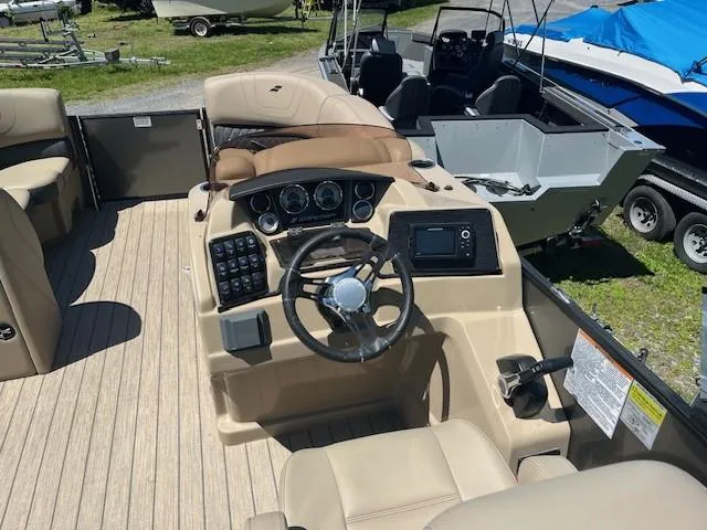 Slide: The Image of 2023 Starcraft SLS3 Q DH boat interior with steering wheel and control panel. - 5