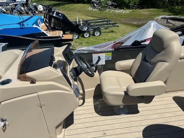 Slide: The Image of 2023 Starcraft SLS3 Q DH boat interior with steering wheel and captain's chair. - 6