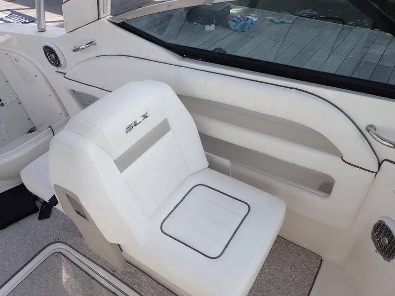 Slide: The Image of 2010 Sea Ray 300 SLX boat interior with white seating and sleek design. - 13
