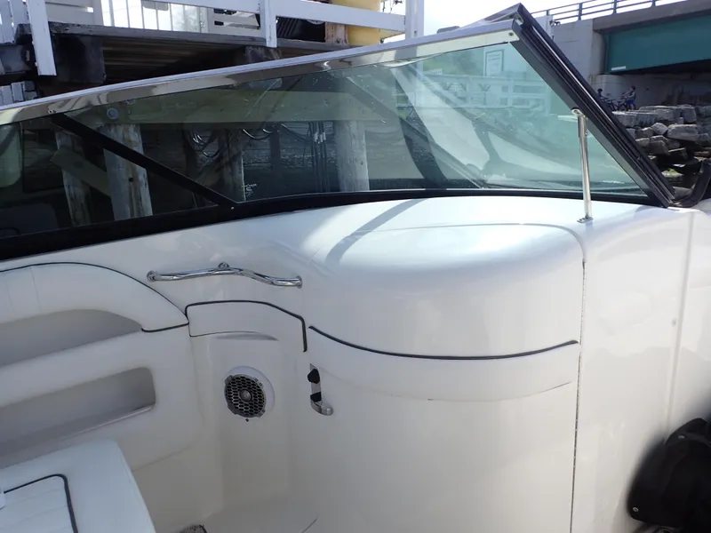 Slide: The Image of 2010 Sea Ray 300 SLX boat interior with windshield and seating area. - 14
