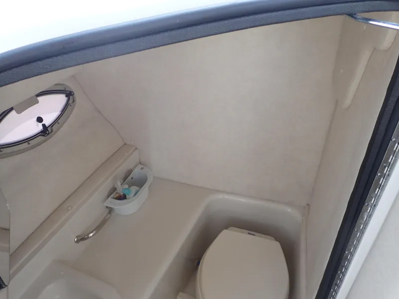 Slide: The Image of Interior of 2010 Sea Ray 300 SLX boat bathroom with toilet and porthole window. - 15