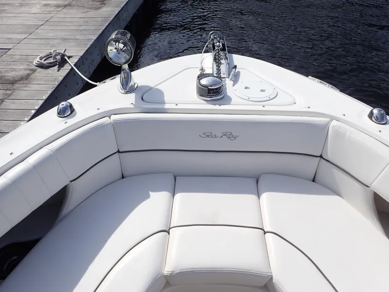 Slide: The Image of 2010 Sea Ray 300 SLX boat with white seating, docked by the water. - 16