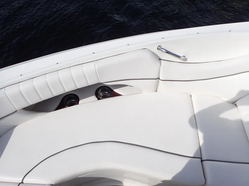 Slide: The Image of White leather seating on a 2010 Sea Ray 300 SLX boat, with cup holders. - 17