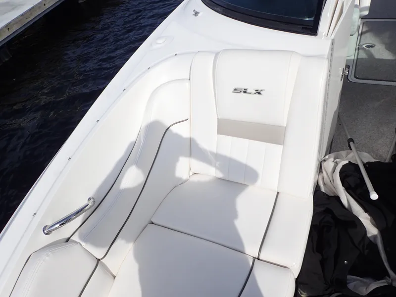 Slide: The Image of White leather seating on a 2010 Sea Ray 300 SLX boat, docked by the water. - 19