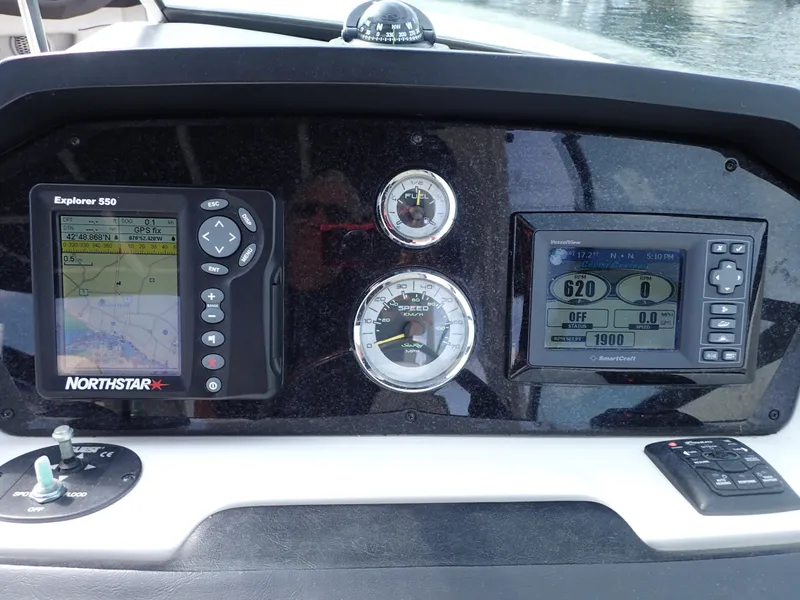 Slide: The Image of Dashboard of a 2010 Sea Ray 300 SLX boat with navigation and control instruments. - 22