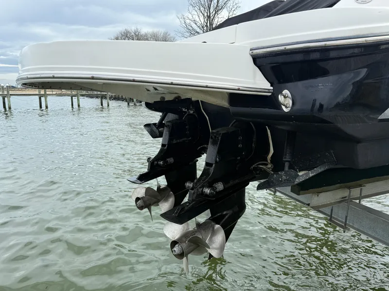 Slide: The Image of 2010 Sea Ray 300 SLX boat with dual propellers on a calm lake. - 25