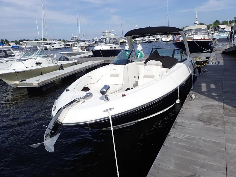 Slide: The Image of 2010 Sea Ray 300 SLX boat docked at marina, featuring sleek design and spacious seating. - 6