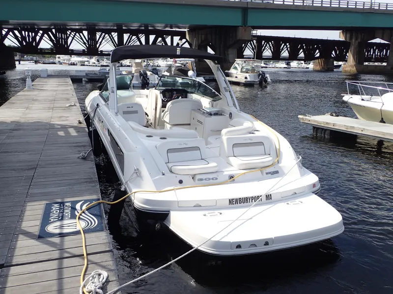 Slide: The Image of 2010 Sea Ray 300 SLX boat docked at marina under bridge. - 9