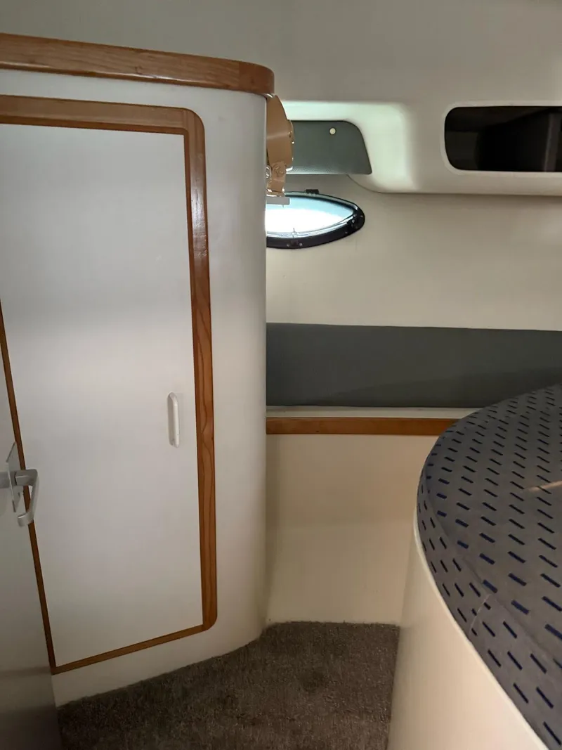 Slide: The Image of Interior of a 1995 Catalina Islander 34 boat, featuring a cozy cabin space. - 14