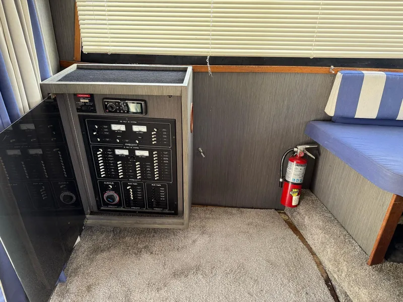 Slide: The Image of Electrical panel and seating area inside a 1995 Catalina Islander 34 boat cabin. - 15