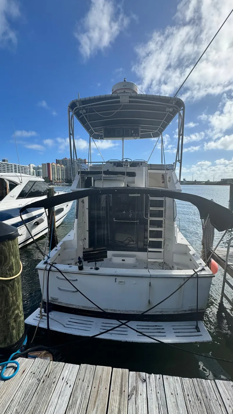 Slide: The Image of 1995 Catalina Islander 34 docked at marina under blue sky. - 17