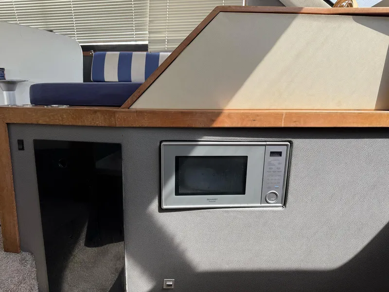Slide: The Image of Interior of 1995 Catalina Islander 34 with built-in microwave and seating area. - 3