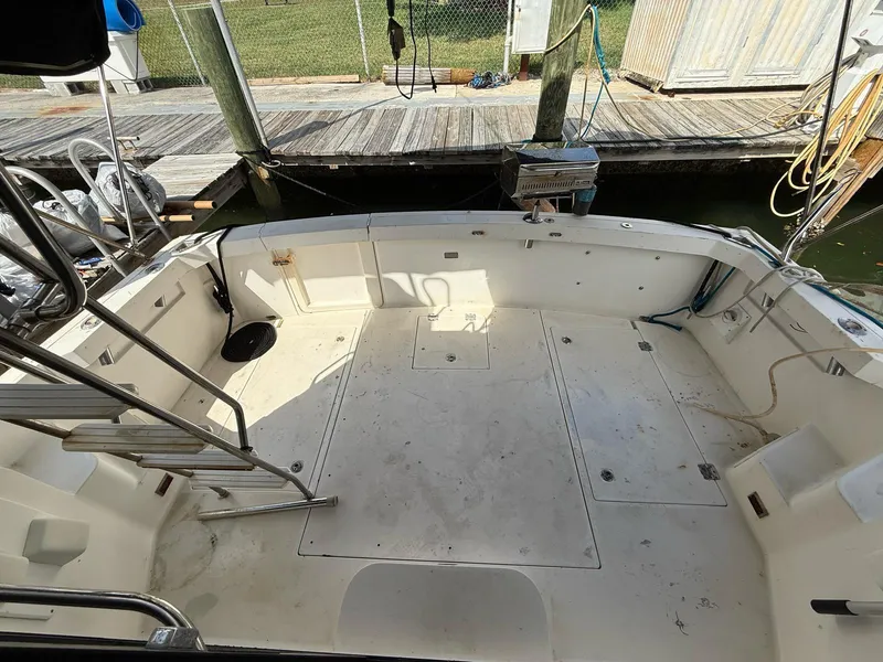 Slide: The Image of 1995 Catalina Islander 34 boat deck with seating and dock view. - 5