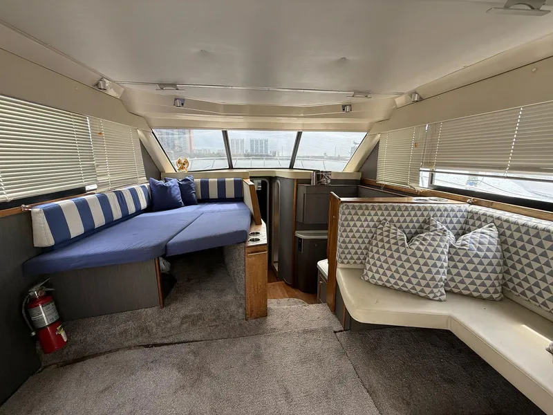 Slide: The Image of Interior of a 1995 Catalina Islander 34 yacht with cozy seating and nautical decor. - 8