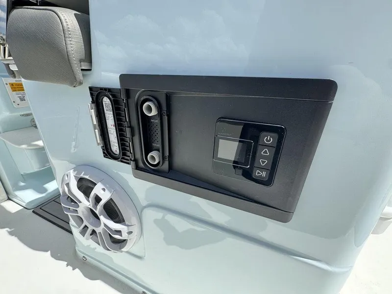 Slide: The Image of 2025 Key West 239 FSR boat dashboard with dual screens and steering wheel. - 11