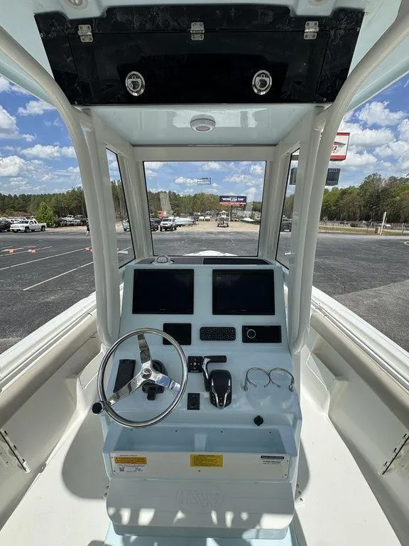 Slide: The Image of 2025 Key West 239 FSR boat interior with tan seating and white deck. - 13
