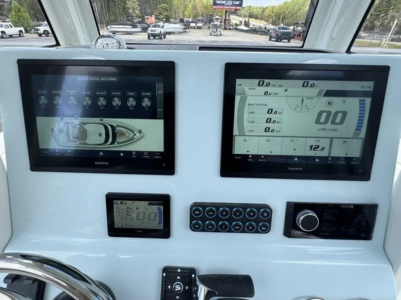 Slide: The Image of 2025 Key West 239 FSR boat interior with brown seating and center console. - 15