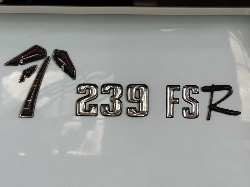 Slide: The Image of 2025 Key West 239 FSR boat interior with seating, cup holders, and sink. - 9