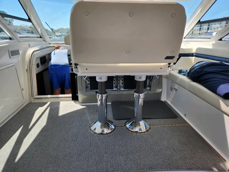 Slide: The Image of Interior of 2011 Sea Ray 540 Sundancer yacht with helm seating and carpeted flooring. - 14