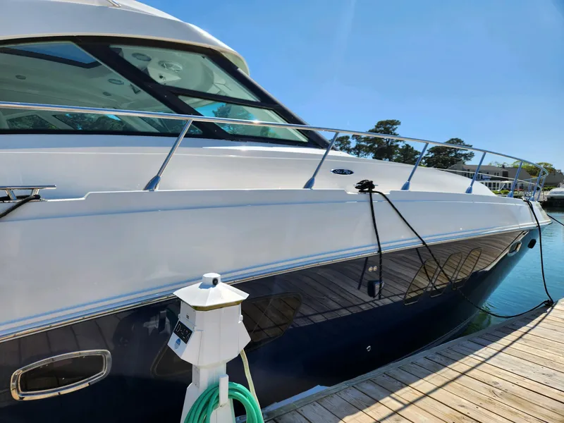 Slide: The Image of 2011 Sea Ray 540 Sundancer yacht docked at marina under clear blue sky. - 6