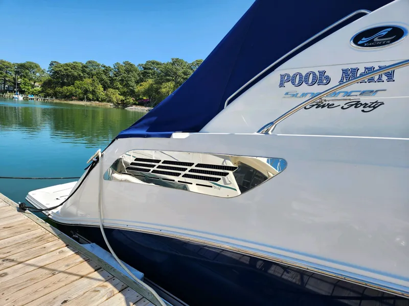 Slide: The Image of 2011 Sea Ray 540 Sundancer yacht docked by serene waters. - 9