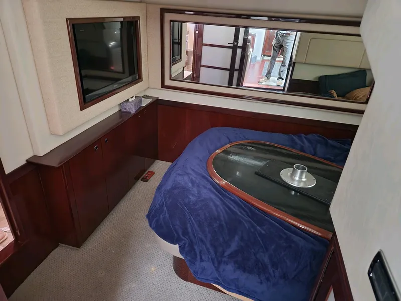Slide: The Image of Luxurious cabin interior of 2011 Sea Ray 540 Sundancer yacht with TV and cozy bedding. - 11