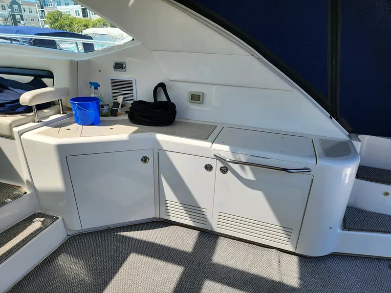 Slide: The Image of 2011 Sea Ray 540 Sundancer yacht interior with storage cabinets and seating area. - 15