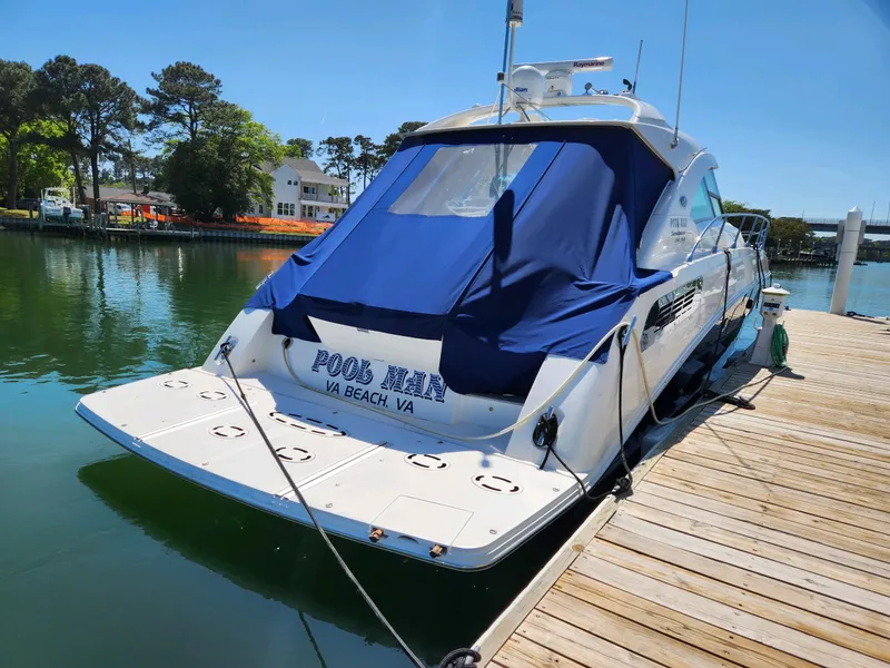 Slide: The Image of 2011 Sea Ray 540 Sundancer docked, featuring a sleek design and blue cover. - 10