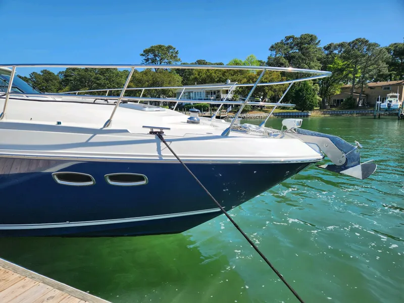Slide: The Image of 2011 Sea Ray 540 Sundancer yacht docked on a sunny day, surrounded by greenery. - 5