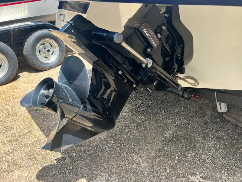 Slide: The Image of 2021 Monterey M22 boat with MerCruiser outdrive and propeller, parked on gravel. - 3