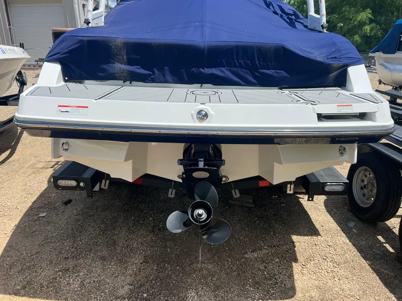 Slide: The Image of Rear view of a 2021 Monterey M22 boat with blue cover and visible propeller. - 4
